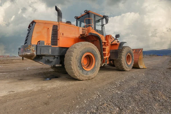 Kazıcı inşaat alanında bir yol inşa ediyor.