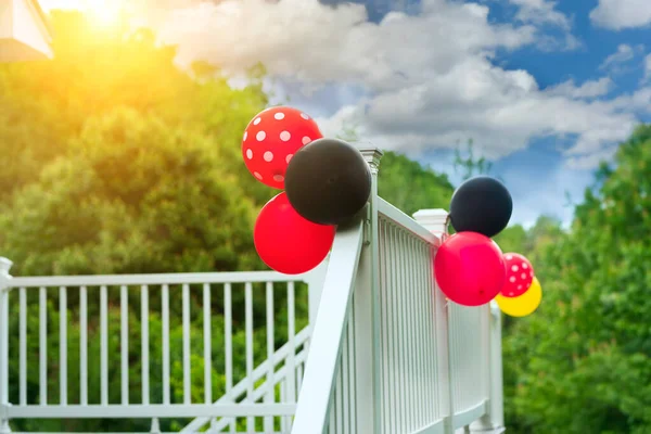 The porch of the house is decorated with balloons for the holiday.