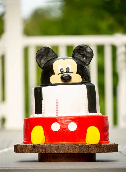 Homemade children\'s bright cake with a muzzle of a mouse. Celebrating the birthday