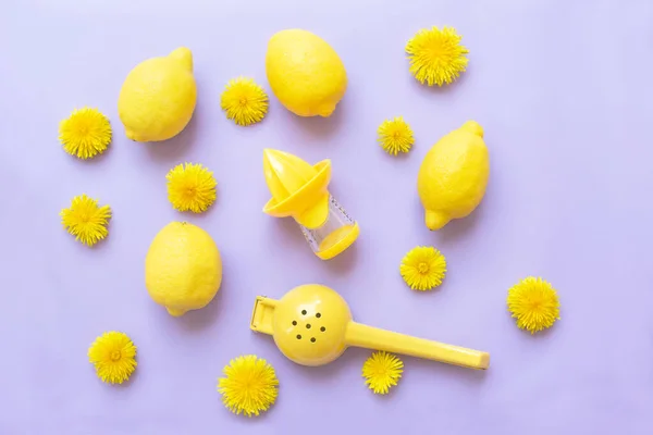 lemons and juice squeezers for lemons on a lilac background.