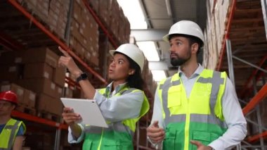 Depo çalışanları malların envanterini tutuyor.