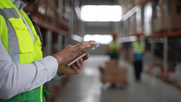 Tablet in hands of warehouse employee during work — Stock Video