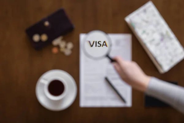 Visa application form on a wooden table, visa processing, registration, flat lay