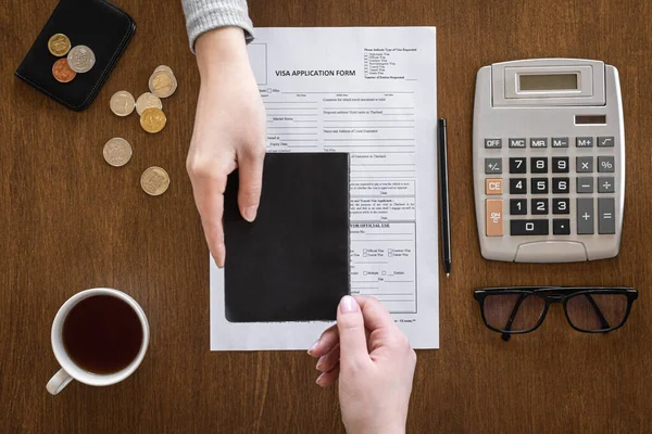 Visa application form on a wooden table, visa processing, registration, flat lay