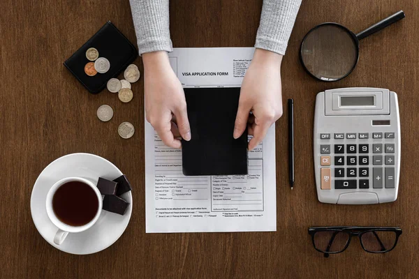 Visa application form on a wooden table, visa processing, registration, flat lay