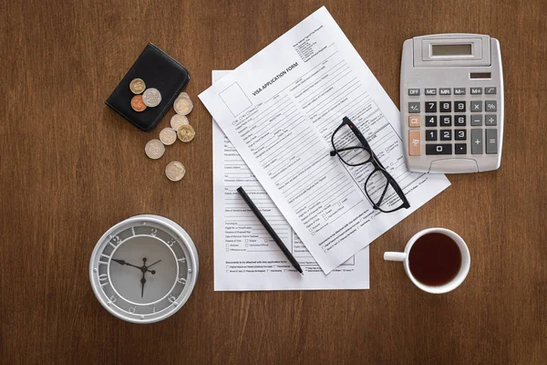 Visa application form on a wooden table, visa processing, registration, flat lay