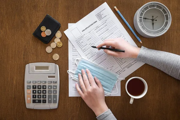 Visa application form on a wooden table, visa processing, registration, flat lay