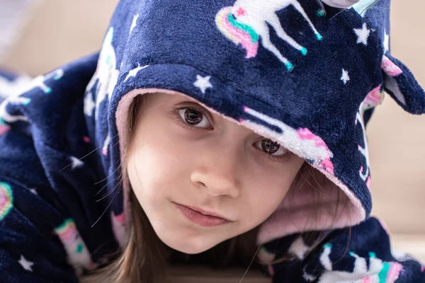 Portrait of a little girl in pajamas with a hood. — Stock Photo, Image