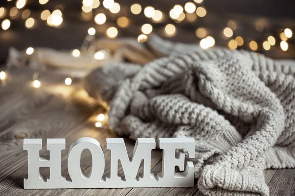 Cozy composition with a decorative word home and knitted element. — Stockfoto