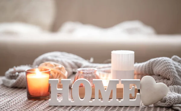 Close up decorative word home on blurred background with candles. — Stock Photo, Image