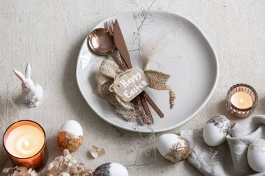 Beyaz masadaki dekorasyon detaylarıyla şenlikli Paskalya tablosu.