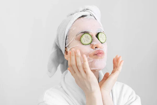 Young woman with sheet mask on her face, spa procedure. — Stock Photo, Image