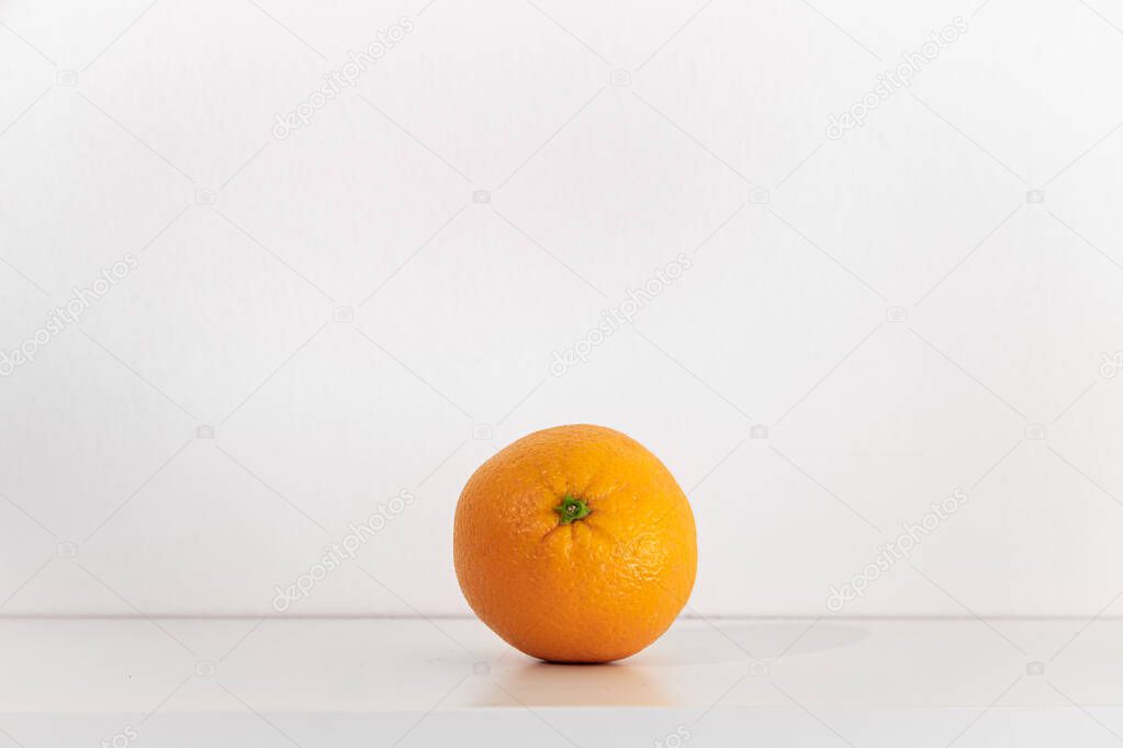 One orange on a white background isolated.
