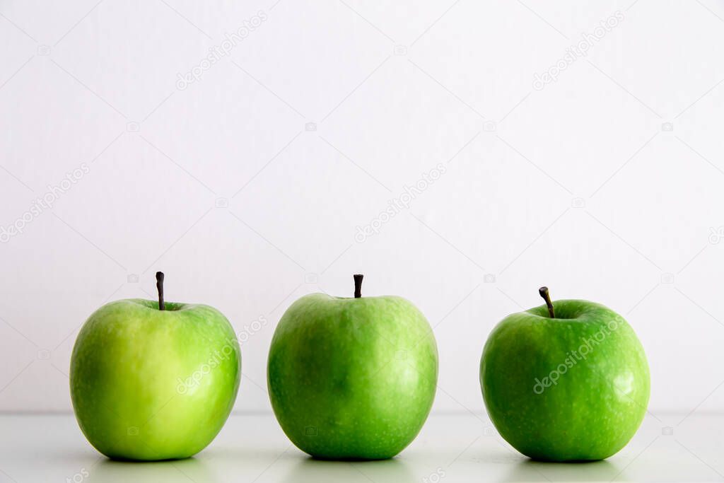 Green apples on a white background close-up.