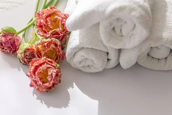 Close-up, white terry bath towels and flowers. — ストック写真