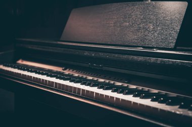Close-up, electronic piano in a dark room.