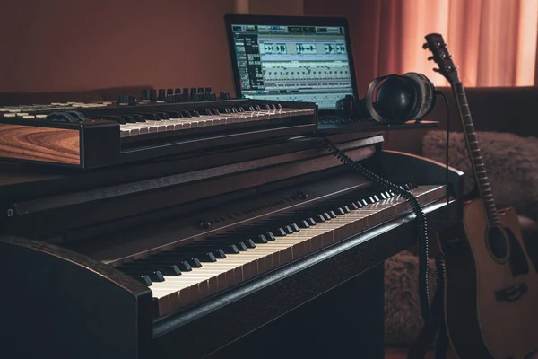 Electronic piano in the interior of the room on a blurred background.