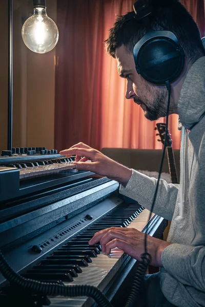 Un hombre compositor, productor, arreglista, compositor, músico manos arreglando la música. — Foto de Stock