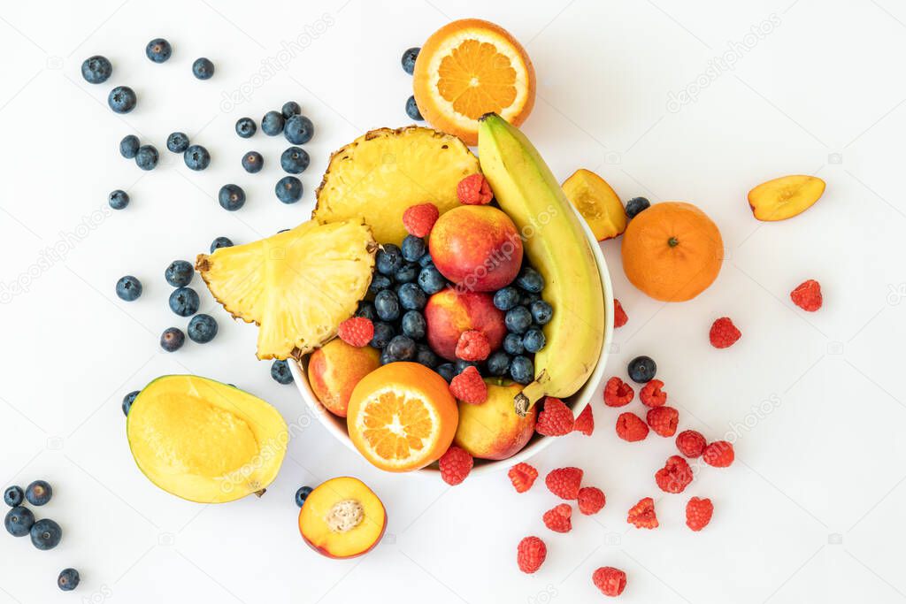Tropical, exotic fruits and berries on a white background top view.
