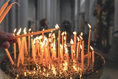 Close-up, candles in the temple on a blurred background, the concept of religion and faith.