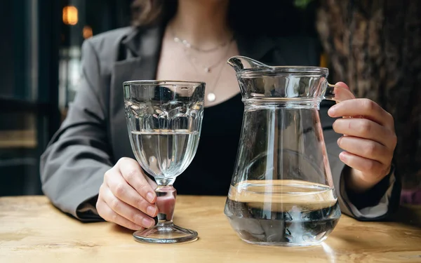 Close Woman Pours Water Glass Jug Glass Goblet Cafe — Foto Stock