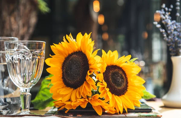 Close-up, a bouquet of sunflowers in a cafe on a table on a blurred background.