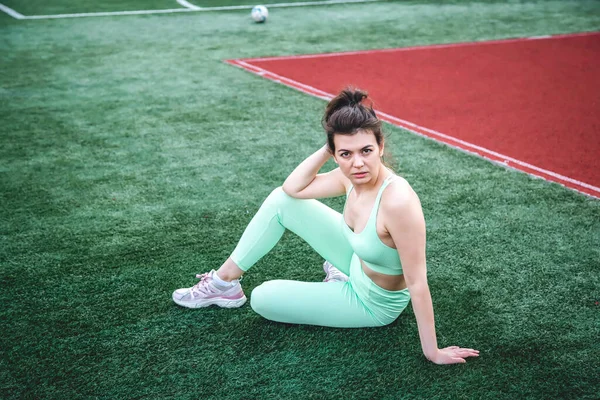 Tired Young Woman Light Green Tracksuit Sits Stadium Workout — Stock Photo, Image