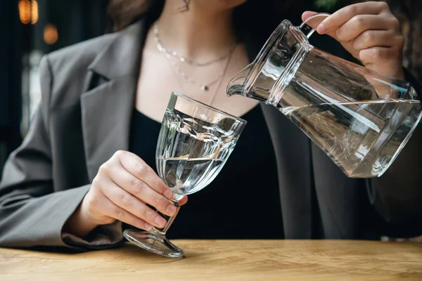 Close Woman Pours Water Glass Jug Glass Goblet Cafe — Foto de Stock