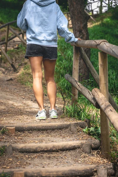Young Woman Climbs Old Wooden Steps Made Logs Wild Park — Stockfoto