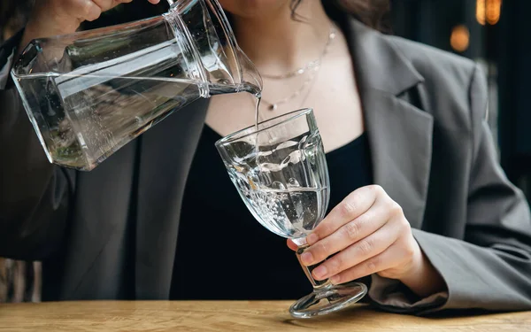 Close Woman Pours Water Glass Jug Glass Goblet Cafe — Foto de Stock