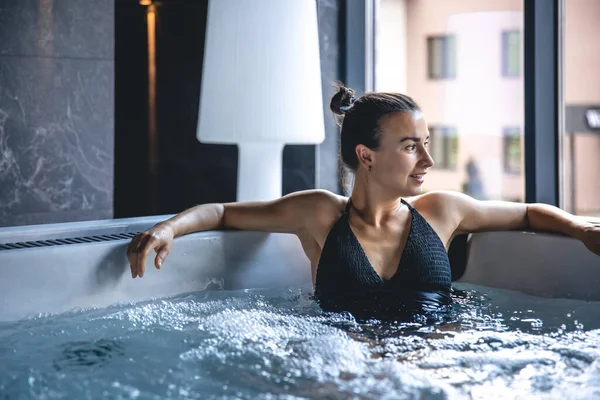 Attractive Young Woman Black Swimsuit Relaxing Jacuzzi — Stockfoto