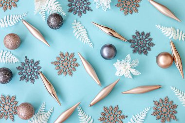 Flat lay, Christmas toys and decor details on a blue background.