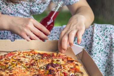 Piece of pizza close-up, concept of picnic and relaxation.