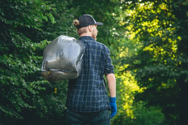 Young Man Gloves Garbage Bag Cleans Forest Concept Caring Nature — Stockfoto