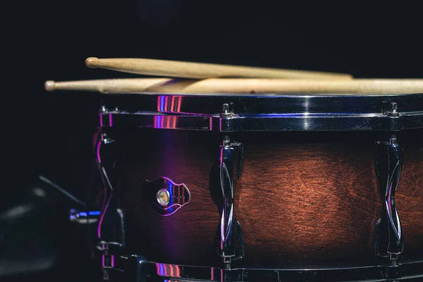 Snare drum on a black background, musical instrument, musical concept.