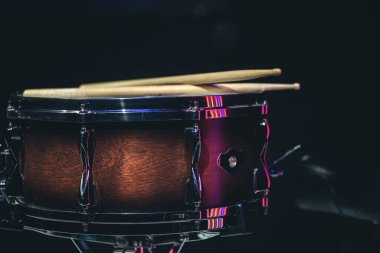 Snare drum on a black background, musical instrument, musical concept.