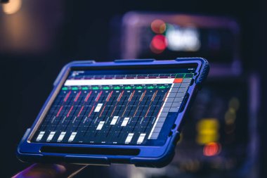 Remote control and sound setting from the tablet, the sound engineer adjusts the sound, copy space.