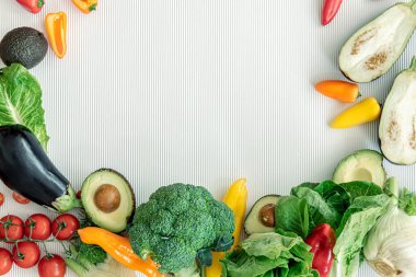A variety of fresh vegetables on a white background, flat lay.