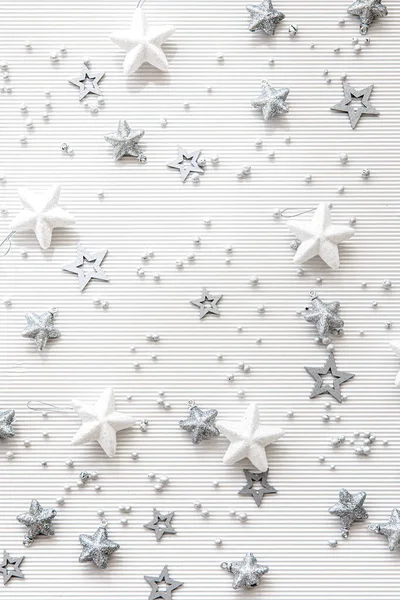 Christmas white background with decorative stars, flat lay.