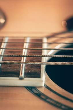 Strings on classical acoustic guitar, macro, guitar detail, music background.