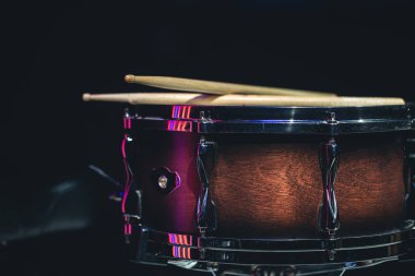 Snare drum on a black background, musical instrument, musical concept.