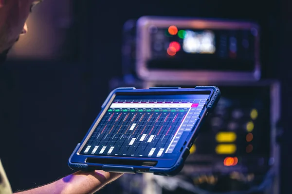 Remote control and sound setting from the tablet, the sound engineer adjusts the sound, copy space.