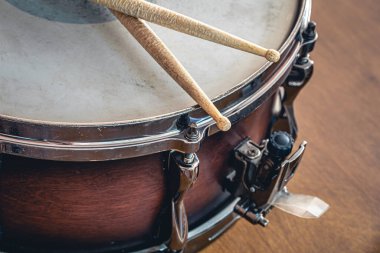 Close-up, drumsticks on a blurred background of a snare drum.