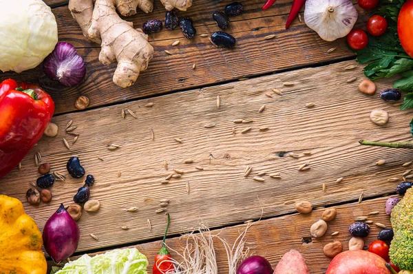 Frame of vegetables on wooden background, flat lay composition, concept of harvest, proper nutrition, ingredients and Thanksgiving.