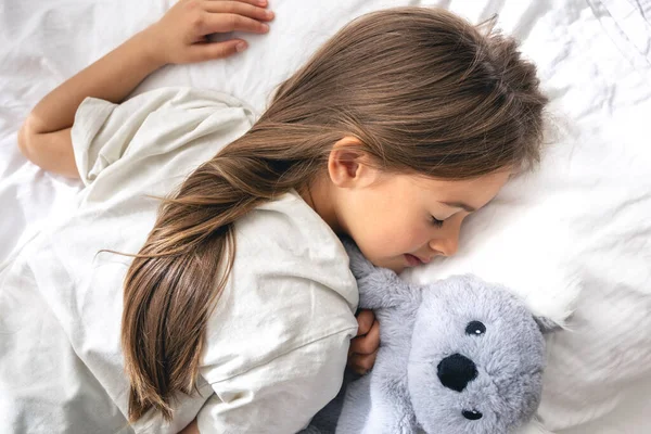 Cute Little Girl Her Favorite Soft Toy Sleeping Sweetly Bed — Stock Photo, Image