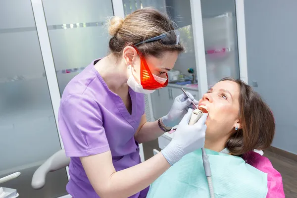 Examination oral cavity or treatment teeth, visiting dental office, soft focus background