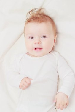 Beyaz battaniye üzerinde Mutlu çocuk, bulanık arka plan, üst görünümü