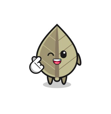 Kurumuş yaprak karakteri Korece parmak kalbi yapıyor, şirin tasarım.