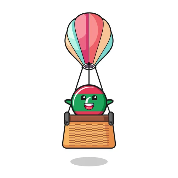 熱気球に乗るモルディブ旗マスコット可愛いデザイン — ストックベクタ