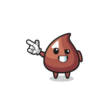 Çikolata parçacıklı maskot sol üst tarafı işaret ediyor, şirin tasarım.